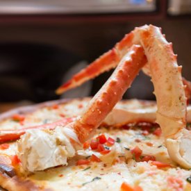 Experience the unique in Alaska, such as this Alaskan king crab leg pizza.