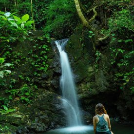 Hike to stunning waterfalls in the Costa Rican rainforest during our Arenal Volcano pre-trip extension.