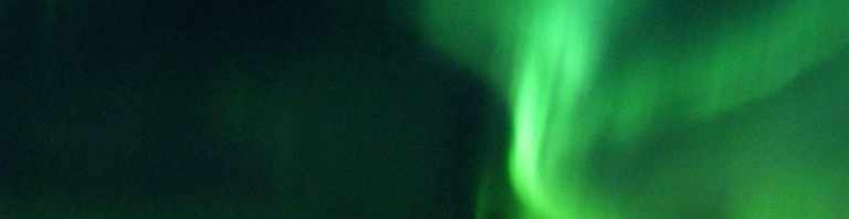 The Aurora Borealis or Northern Lights shine above 1