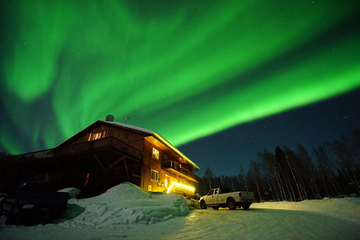 viewing northern lights in Alaskan log cabin