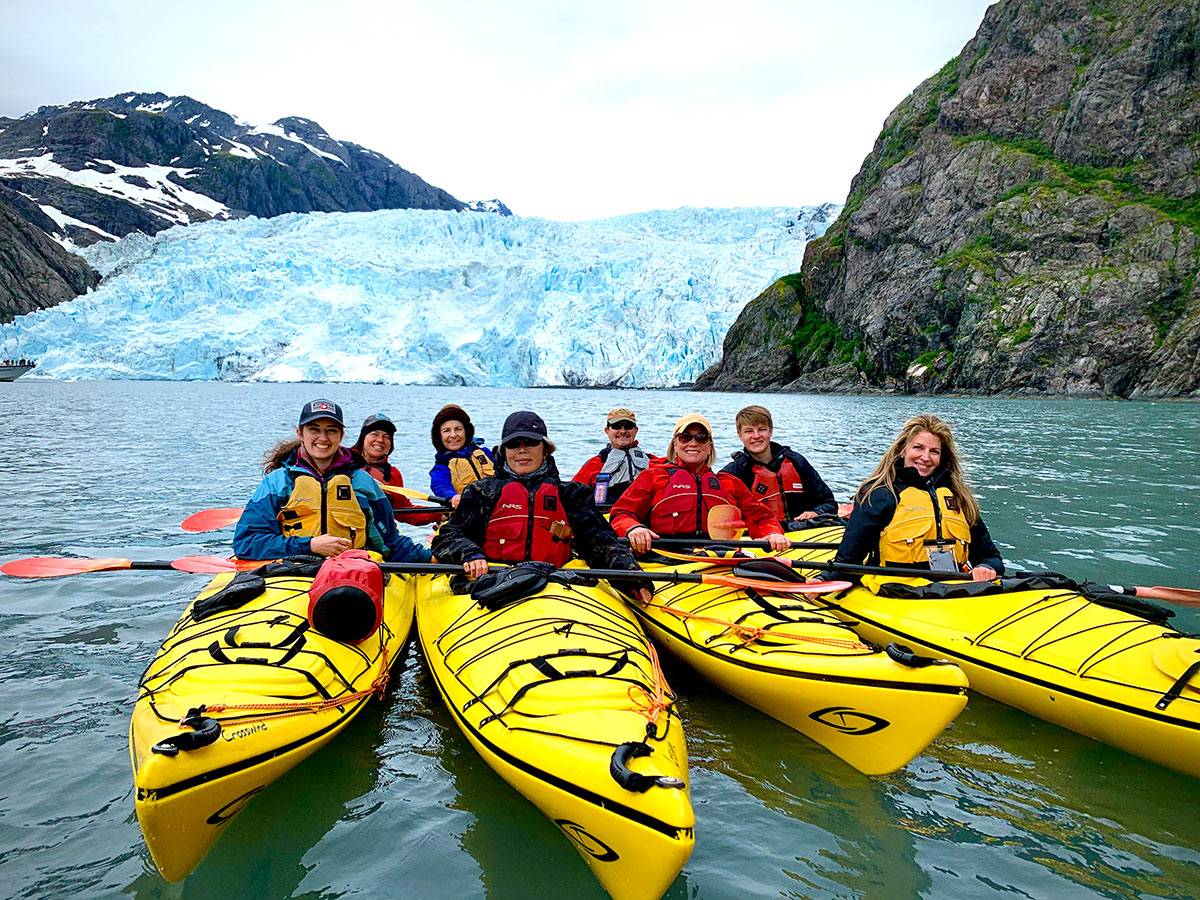group of people kayaking near glaciers in Alaska