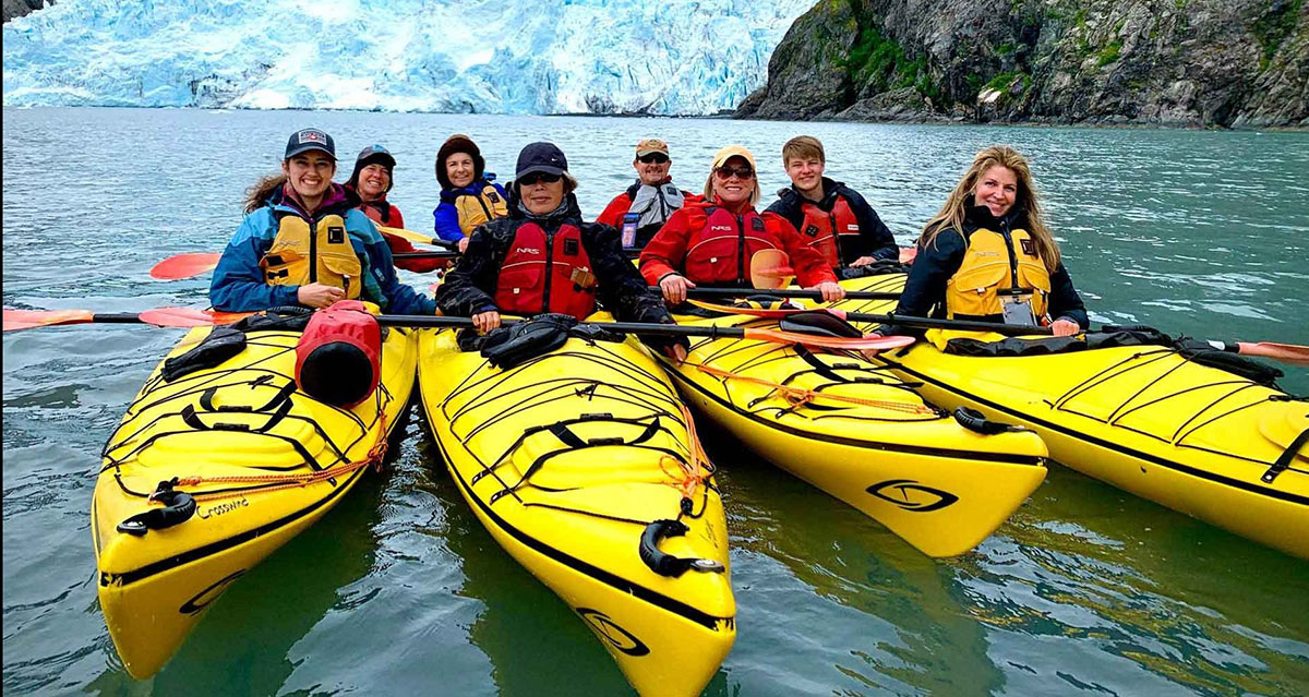 group of kayakers in Alaska near glaciers