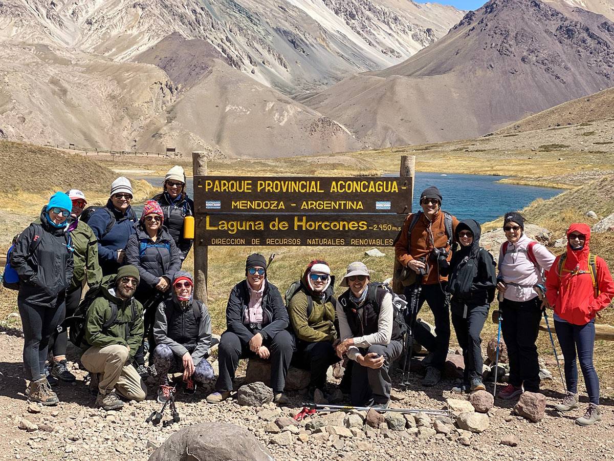 group of guests posing by sign in argentina 1