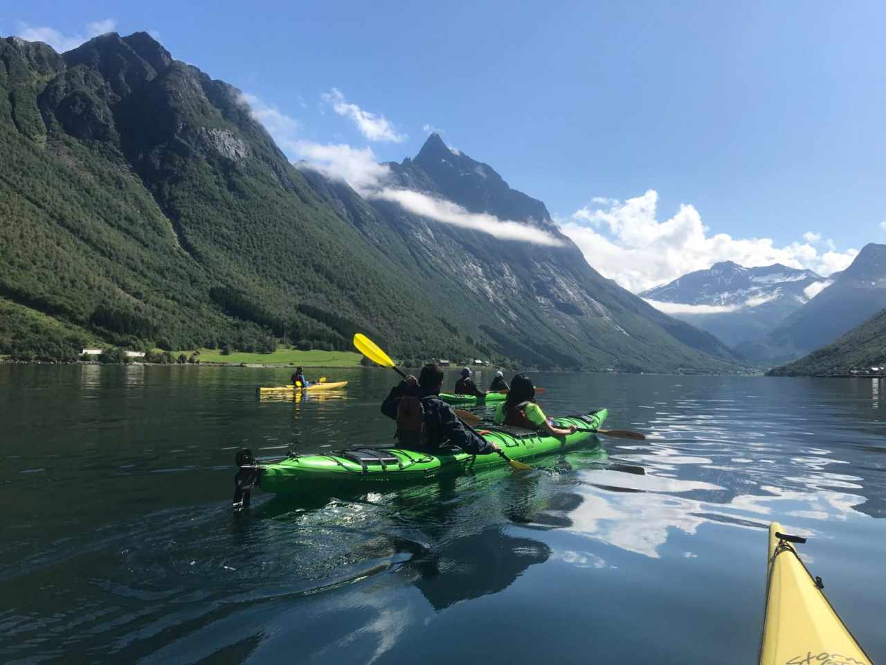 People kayaking through the Western Fjords of Norway