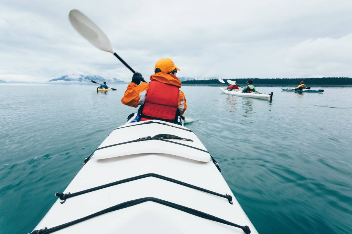Kayaking group in calm waters in Alaska