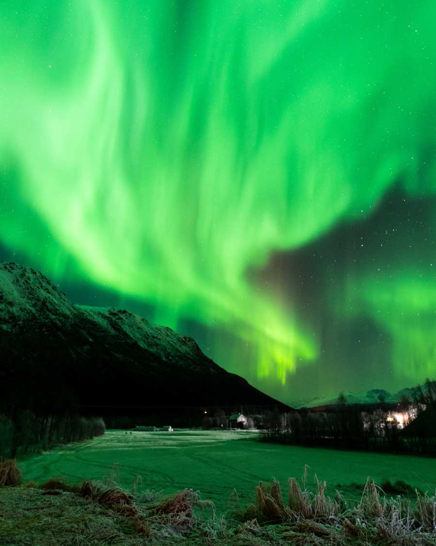 aurora lights in shades of green over mountain landscape